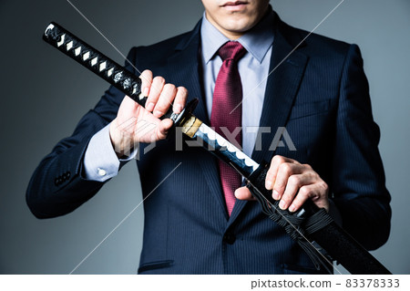 A businessman with a Japanese sword 83378333