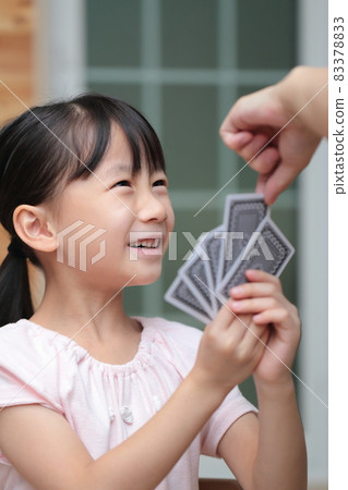 Girl playing cards to maid 83378833