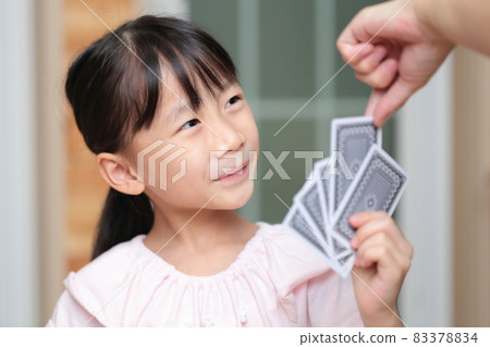 Girl playing cards to maid 83378834
