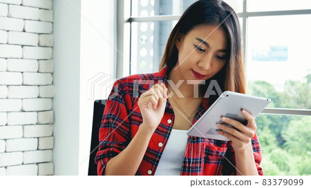 Asian woman using digital tablet shopping online, call, texting message internet technology lifestyle with smiling face. Asian woman touch smart tablet focus on hands using mobile app home office. Asian woman using digital tablet shopping online, call, texting message internet technology lifestyle with smiling face. Asian woman touch smart tablet focus on hands using mobile app home office. 83379099