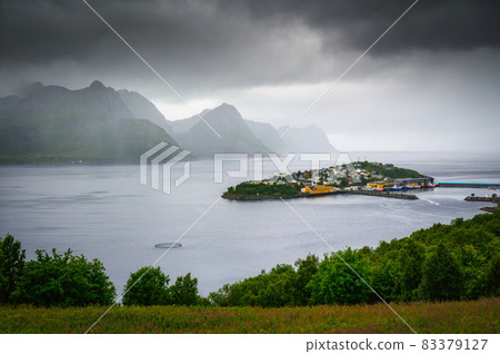 Husoy fishing village on the Senja Island in Norway with in heavy clouds Husoy fishing village on the Senja Island in Norway with in heavy clouds 83379127