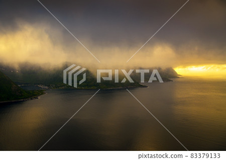 Aerial view of fog covered mountains on Senja island in Norway seen at sunset 83379133