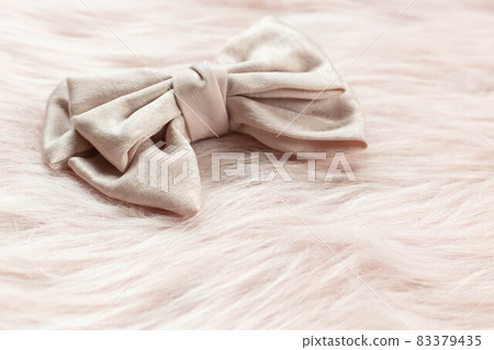 Luxury hair clip on pink fabric with copyspace. Luxury hair clip on pink fabric with copyspace. 83379435
