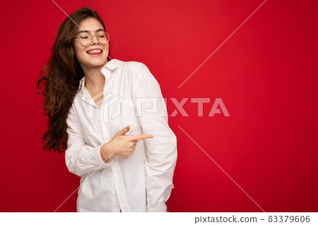 Portrait of beautiful positive cheerful cute smiling young brunette woman in casual white shirt and Portrait of beautiful positive cheerful cute smiling young brunette woman in casual white shirt and 83379606