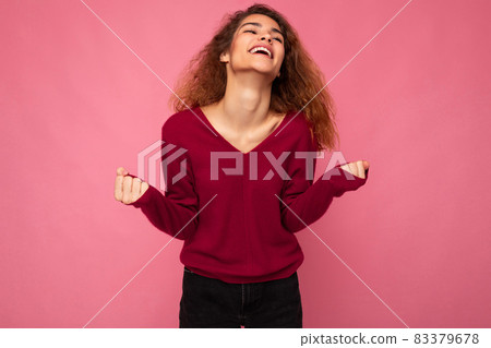 Photo of young emotional happy positive beautiful brunette curly woman with sincere emotions wearing Photo of young emotional happy positive beautiful brunette curly woman with sincere emotions wearing 83379678