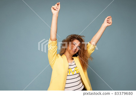 Photo shot of pretty joyful smiling young female person wearing casual trendy outfit standing 83379680