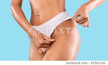 Unrecognizable Lady Posing In Panties Isolated On Blue Studio Background 83381180