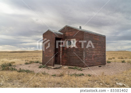 old, metal, rusty shack on a prairie 83381402