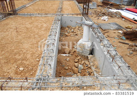 KUALA LUMPUR, MALAYSIA -MARCH 29, 2021: Building ground beam under construction at the site using timber plywood as the formwork. The concrete was reinforced by the steel reinforcement bar KUALA LUMPUR, MALAYSIA -MARCH 29, 2021: Building ground beam under construction at the site using timber plywood as the formwork. The concrete was reinforced by the steel reinforcement bar 83381519