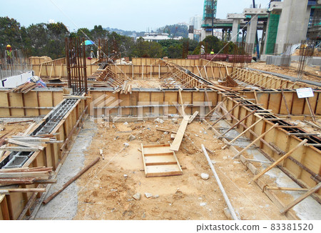KUALA LUMPUR, MALAYSIA -MARCH 29, 2021: Building ground beam under construction at the site using timber plywood as the formwork. The concrete was reinforced by the steel reinforcement bar KUALA LUMPUR, MALAYSIA -MARCH 29, 2021: Building ground beam under construction at the site using timber plywood as the formwork. The concrete was reinforced by the steel reinforcement bar 83381520