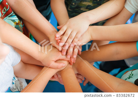 Team building. Children's hands. Group activity for children. The concept of achieving a common goal in a team. Team building. Children's hands. Group activity for children. The concept of achieving a common goal in a team. 83382672
