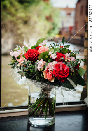flowers bouquet on the window with water background 83382903
