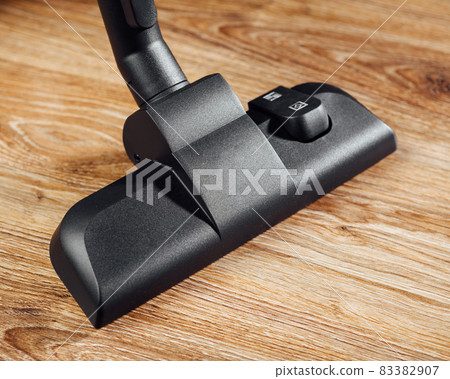 vacuum cleaner brush on wooden floor 83382907