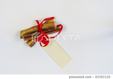 Dog treats and rectangular sales tag on white. Air dried pet che Dog treats and rectangular sales tag on white. Air dried pet che 83383120