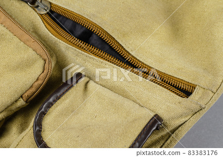 Close-up of a fragment of a shoulder bag on a gray background. O 83383176
