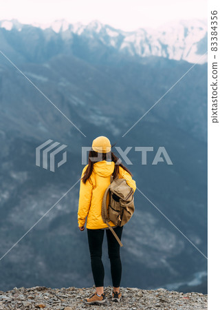 A man travels through the Caucasus. Mountain sports. Mountain tourism. Walking tour. The journey to the mountains. Man on the background of mountains. Copy space 83384356