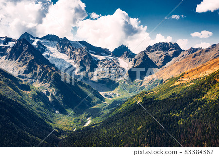 Stunning view of the mountain gorge. Mountain landscape. Beautiful view of the snow-capped mountain peaks. Panoramic view of the glacier. The Caucasus mountain range. Beautiful scenery. Copy space 83384362