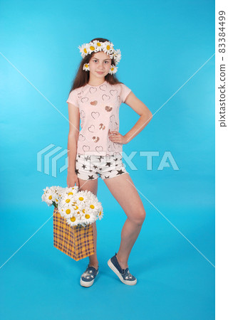 Beautiful girl with chamomile wreath 83384499