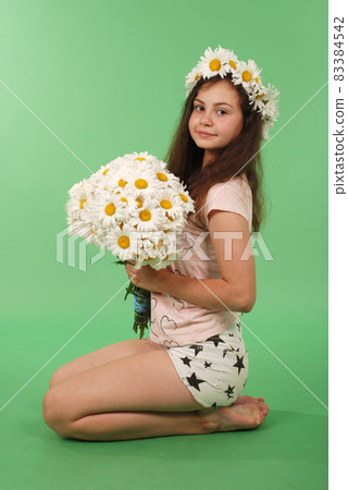 Beautiful girl with chamomile wreath Beautiful girl with chamomile wreath 83384542