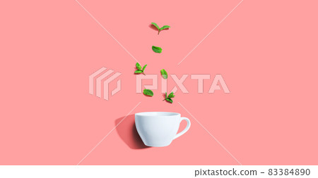 Fresh mints with tea cup overhead view Fresh mints with tea cup overhead view 83384890