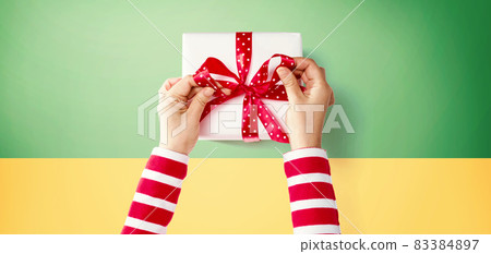 Person making a Christmas gift box Person making a Christmas gift box 83384897