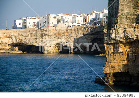 White buildings on grottos and cliffs in the town of Polignano a mare in Puglia White buildings on grottos and cliffs in the town of Polignano a mare in Puglia 83384995