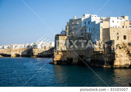 White buildings on grottos and cliffs in the town of Polignano a mare in Puglia White buildings on grottos and cliffs in the town of Polignano a mare in Puglia 83385007