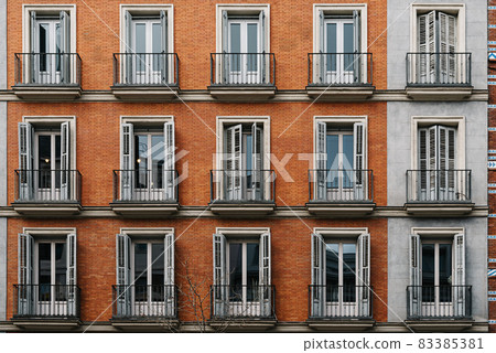 Elevation View of Old Luxury Residential Building with Brick Facade and Balconies Elevation View of Old Luxury Residential Building with Brick Facade and Balconies 83385381