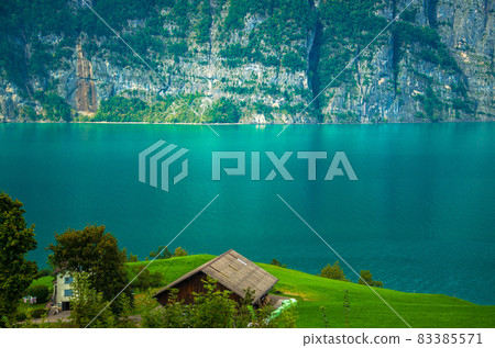Village house near Lake Walensee and mountain chain, Switzerland Village house near Lake Walensee and mountain chain, Switzerland 83385571