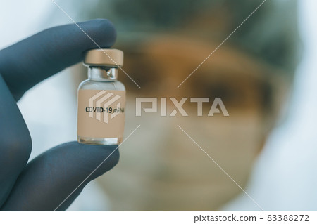 Healthcare workers with vials of corona vaccine 83388272