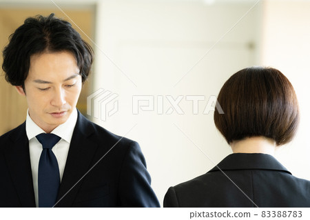 Men and women in suits passing each other in the corridor Men and women in suits passing each other in the corridor 83388783
