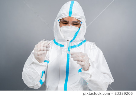 doctor in protective suit PPE holding Coronavirus(COVID-19) Nasal swab laboratory test 83389206