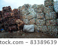 Bundle of pressed plastic bottles prepared for a garbage recycling on waste recycling plant. Camera moves forward. Pollution problem. Stabilized video 83389639