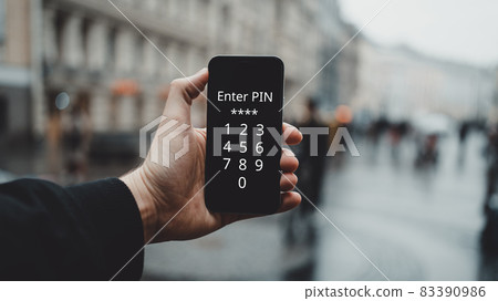 The person holds up a smartphone and enters a pin code. The person holds up a smartphone and enters a pin code. 83390986