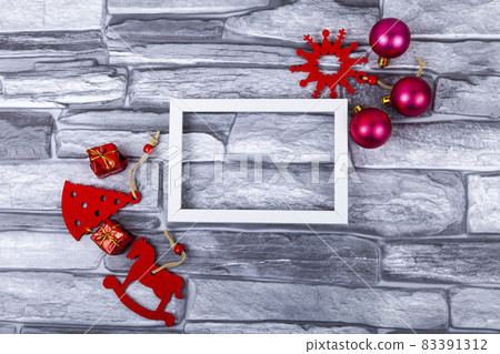 Frame and Christmas decor on a gray background. Christmas card. Frame and Christmas decor on a gray background. Christmas card. 83391312