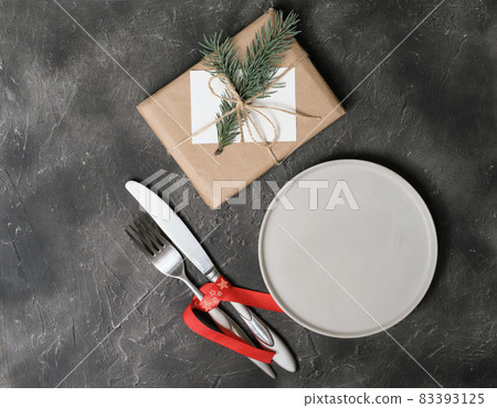 empty plate with tableware and christmas decor on grey table. copy space. table setting template for new year or christmas menu. restaurant menu mock up. top view empty plate with tableware and christmas decor on grey table. copy space. table setting template for new year or christmas menu. restaurant menu mock up. top view 83393125