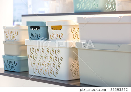 Plastic containers on a shelf on a rack for organizing home space, order and interior, sale of household goods Plastic containers on a shelf on a rack for organizing home space, order and interior, sale of household goods 83393252