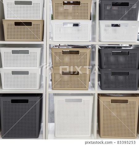 Plastic container boxes on a shelf on a rack for organizing home space, order and interior, sale of household goods. Industrial background 83393253