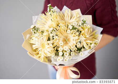 Beautiful bouquet of mixed flowers in woman hand. Floral shop concept . Beautiful fresh cut bouquet. Flowers delivery Beautiful bouquet of mixed flowers in woman hand. Floral shop concept . Beautiful fresh cut bouquet. Flowers delivery 83393871