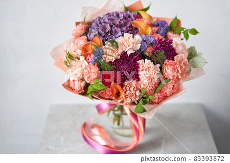 Beautiful bouquet of mixed flowers in woman hand. Floral shop concept . Beautiful fresh cut bouquet. Flowers delivery Beautiful bouquet of mixed flowers in woman hand. Floral shop concept . Beautiful fresh cut bouquet. Flowers delivery 83393872