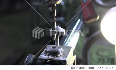 Close-up image of a engineer working with metal drill Close-up image of a engineer working with metal drill 83394087
