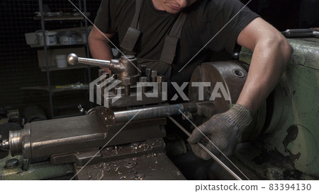 Metal spiral production on lathe in workshop 83394130