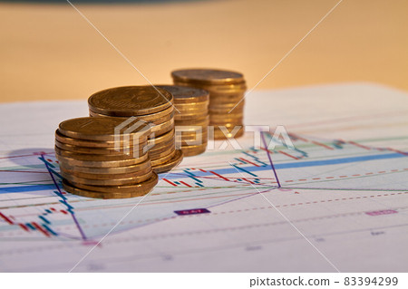 Stacks of money coins with graph paper. 83394299