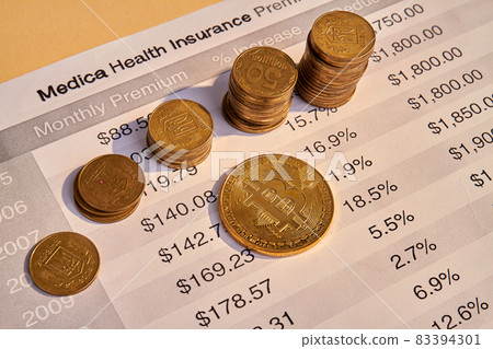 Medical health insurance bill and many golden coins. 83394301