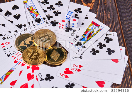 Close-up bitcoins with cards and dices on wooden desk. Close-up bitcoins with cards and dices on wooden desk. 83394516