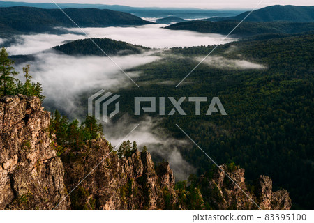 Fog in the mountains at sunrise. Morning fog in the mountains at dawn. Clouds in the mountains. Morning fog after rain. Mountains at dawn. Milk rivers. Copy space Fog in the mountains at sunrise. Morning fog in the mountains at dawn. Clouds in the mountains. Morning fog after rain. Mountains at dawn. Milk rivers. Copy space 83395100