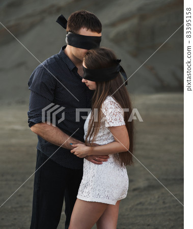 Romantic couple blindfolded with black ribbon. Love blind concept 83395158