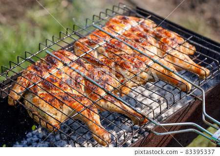 Chicken grilled on a charcoal barbeque brazier Chicken grilled on a charcoal barbeque brazier 83395337