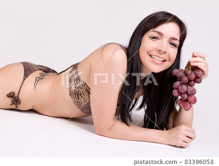 beautiful girl with grapes 83396058