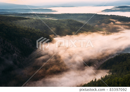 Fog in the mountains at sunrise. Morning fog in the mountains at dawn. Clouds in the mountains. Morning fog after rain. Mountains at dawn. Milk rivers. Copy space 83397092